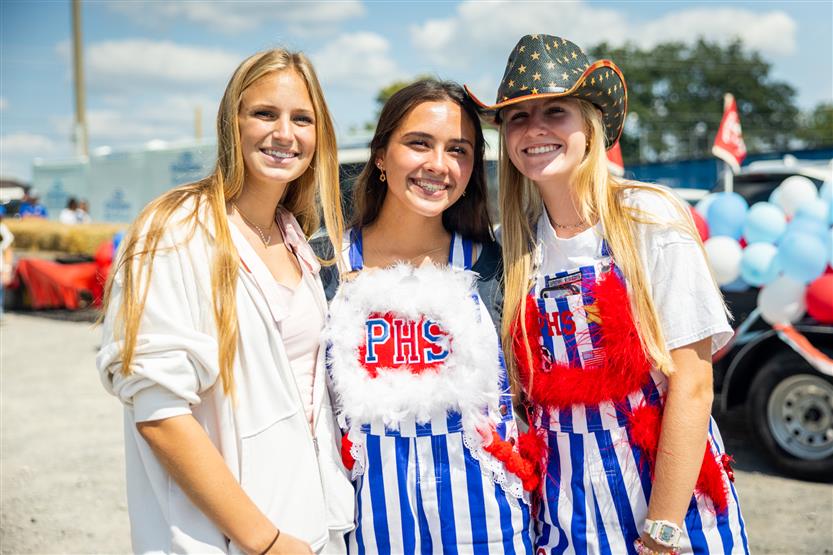 Three girls wearing Page High paraphernalia smile